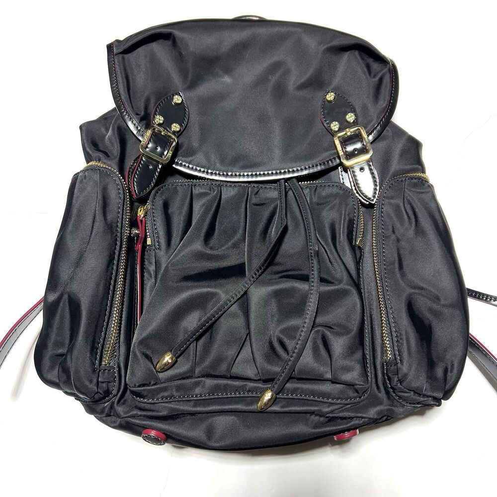 MZ Wallace Marlena backpack in black nylon and leather with red accents.